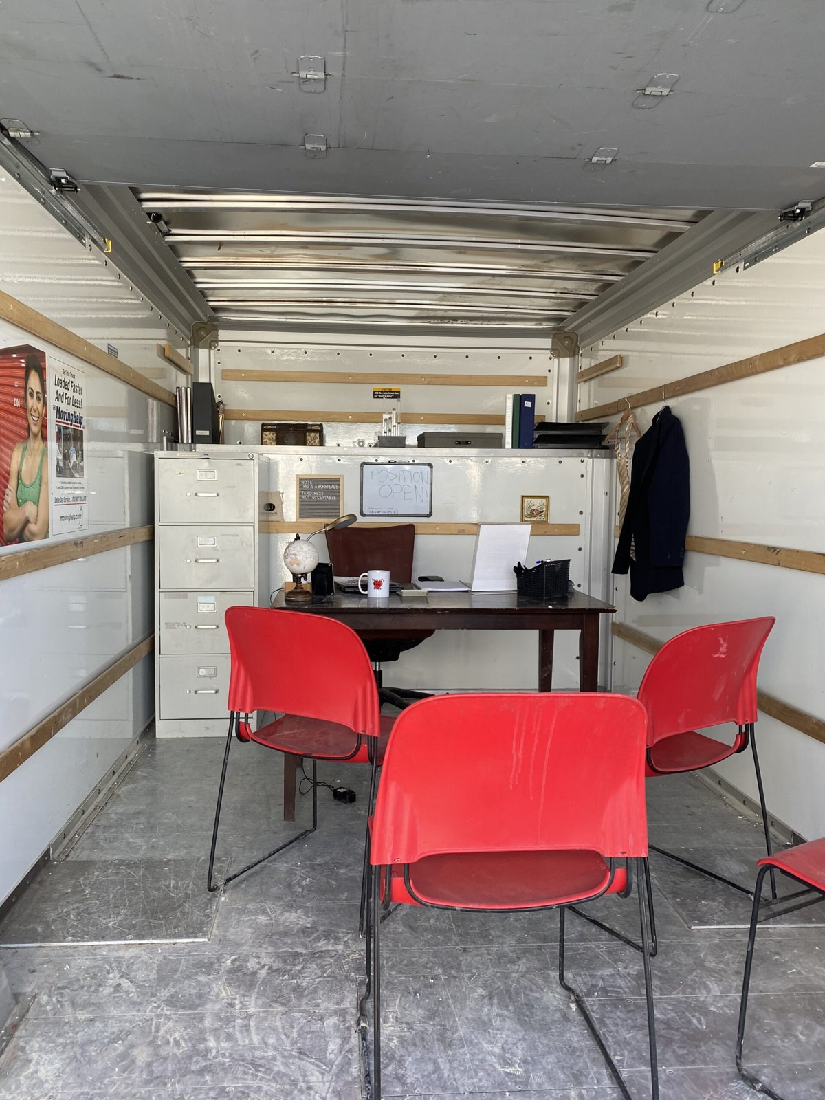 The Interview installation: a red-chaired office set built inside a truck at Burning Man